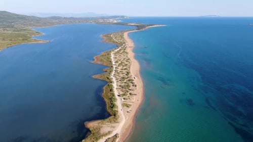 Aerial View of a Long Sandy Beach Spit Separating a Lagoon from the Open Sea in a Scenic Landscape