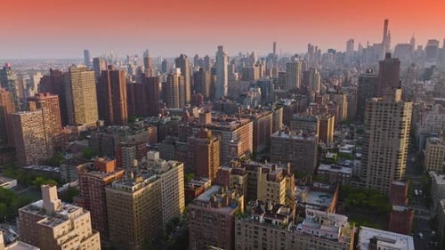 Gorgeous pink skyline over vast city. New York architecture at beautiful sunrise. Aerial perspective