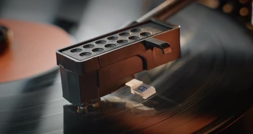 Macro Close Up of Stylus Needle Touching Grooves Playing Song on Vinyl Record Player
