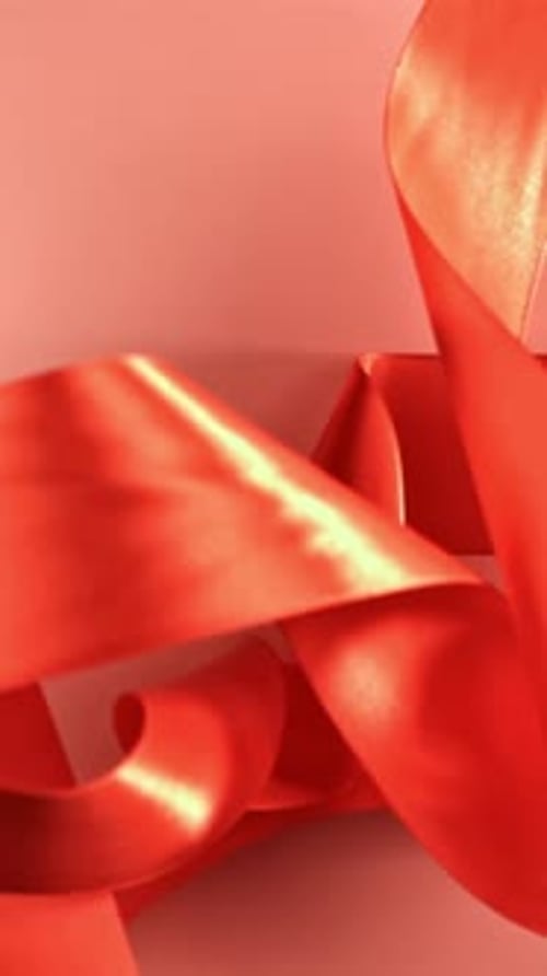 A Red Ribbon Falls on the Table Filmed on a Highspeed Camera at 1000 Fps