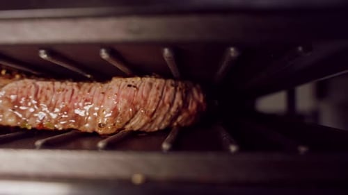 Slow Motion Close Up Of Steak Searing On Grill With Visible Juices And Browning Surface Emphasizing
