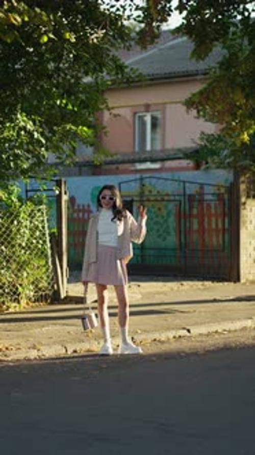 Cheerful Woman Enjoys Sunny Afternoon in Suburbs Concept of Playful Suburban Charm