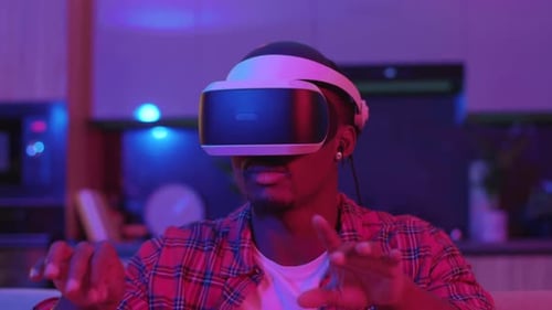 Man Using VR Headset in Dark Room