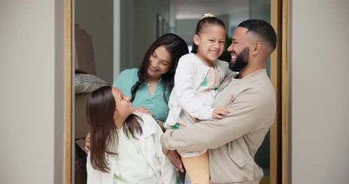 Happy Family Smiling in Doorway of New Home