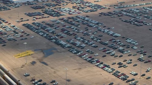 New Cars Parked on Automotive Factory Parking Lot for Worldwide Export Dealer Vehicle Inventory