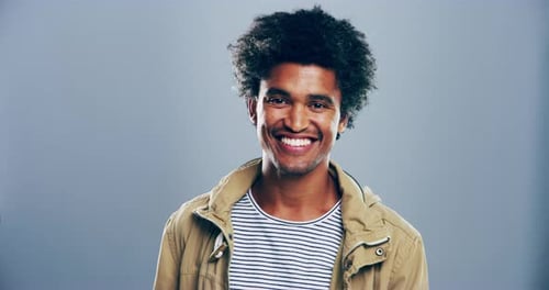 Smiling Young Adult Makes Heart Shape with Hands