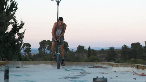 Man Balances on Unicycle on Rooftop
