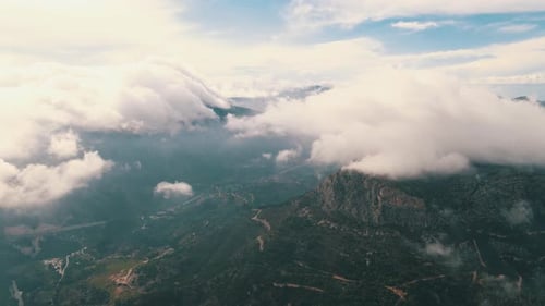 Aerial view of cloudy mountains. Stunning landscape in drone shot.