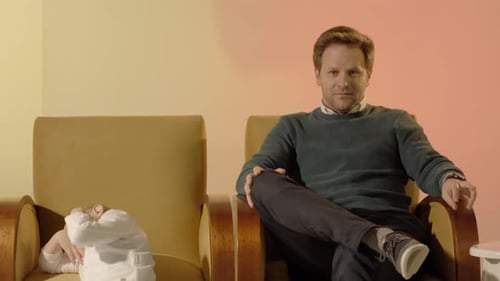 Man and Child Seated in Chairs Indoors
