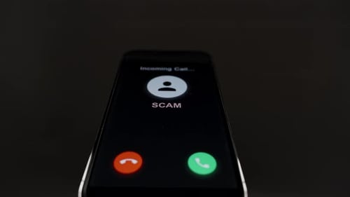 A smartphone shows an incoming "SCAM" call, raising awareness about scam calls and the importance of