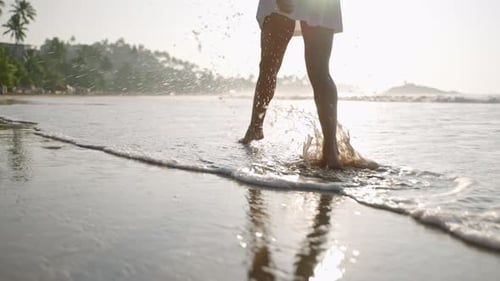 Female Feet Walking Barefoot in Sea Surf Waves Person's Legs Running Along Sandy Coast Attractive