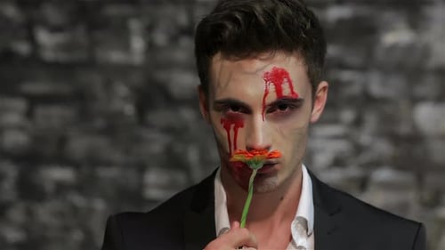 Man with Halloween Makeup Holds Flower