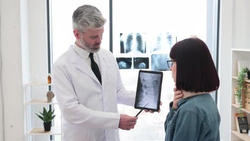 Doctor Explains Spinal X-Ray to Female Patient