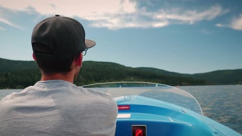 Back view of man controlling and driving electric boat ship
