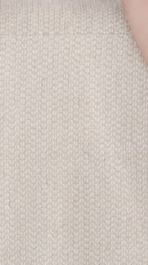 Vertical video. A Man's Hand Touches the Texture of White Fabric on the Sofa. Close-Up.