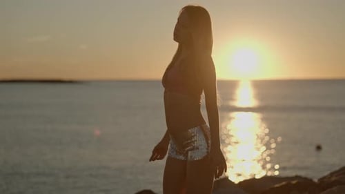 Woman at Sunrise By the Sea