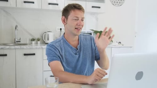Young Man on Video Call in Bright Kitchen