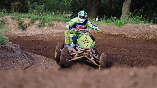 Tracking shot of Quad Racer Turning on Dirt Track During Competition Race in Berlin