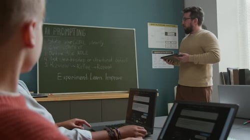 Young Caucasian Male Teacher Explaining AI Prompting Rules to Students