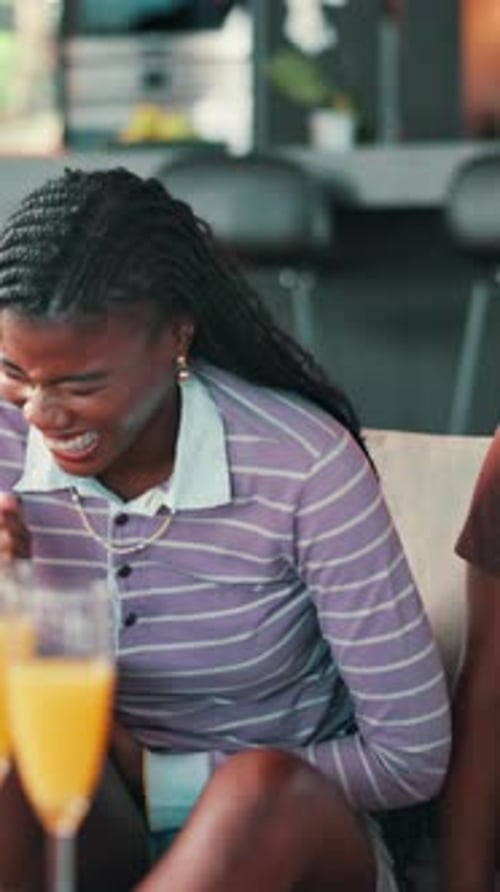 Woman with Braids Smiling and Toasting Mimosa