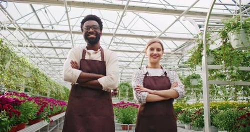 Front Camera View of Two Florists Standing Close to Each Other Looking at Camera While Smiling