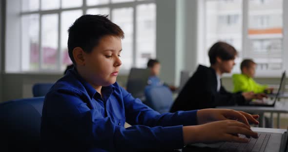 Cute Little Boy Learning Coding In IT Classes Portrait Of School ...