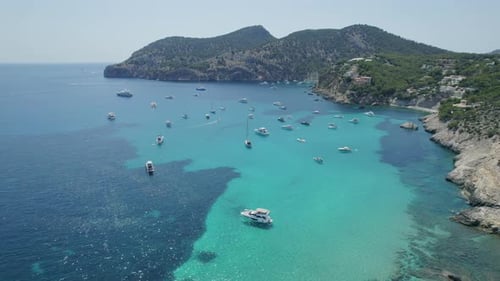 Aerial rocky Mediterranean coastline with private boats Mallorca, Spain