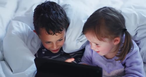 Children Watching Tablet Together in Bed