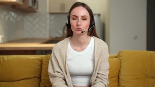 Woman with headset talking on a couch