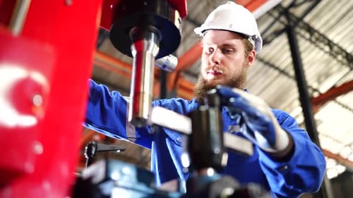Worker Operating In Manual Lathe. Metalworker in the workshop.