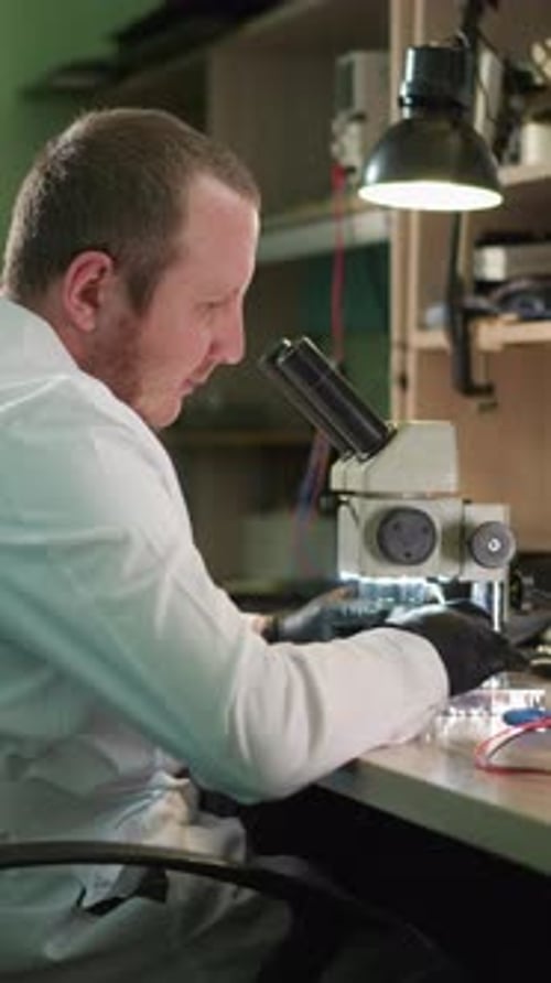 Scientist Using Microscope in Lab