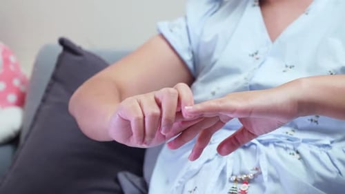 Pregnant woman massaging her hand joints due to pain.