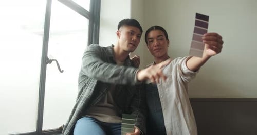 Young Couple Choosing Colors in Their Home