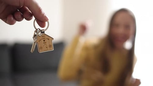 Focused Key Presented to Excited Woman for Her New Home
