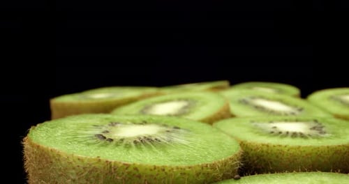 Juicy fresh kiwi fruit cut in half super high quality close up shoot fly over 4k shoot on dark backg