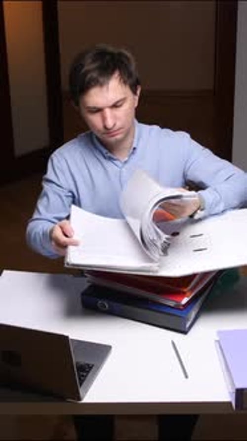 Vertical Video Office Worker Searching Documents in a Messy Archive at Night