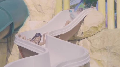 Little girl's joyful waterslide adventure at playa del carmen resort in Mexico