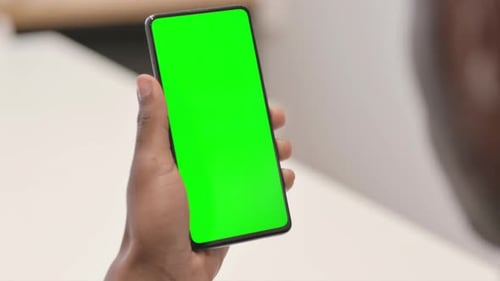 Close up of African Man Using Smartphone with Green Screen