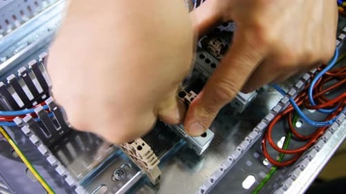 Hands Assembling Electrical Components in Electrical Box