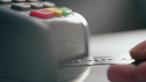 Close Up Of A Female Hand Inserts A Payment Card Into The Terminal For Online Payments, The Process