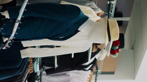 Vertical Video Interior of Fashionable Boutique with New Collection on Hangers