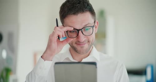 Young Adult Using Tablet in Workplace