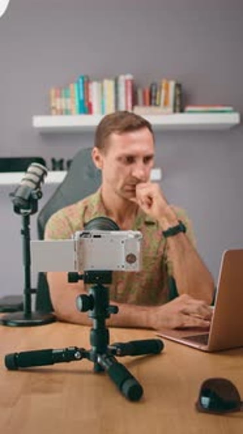 Man Works at Desk Filming Himself