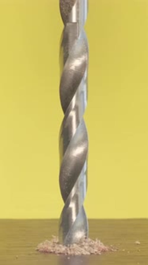A Selftapping Screw in a Wooden Block on a Yellow Background Screwdriver Screw Lag Bolt Vertical