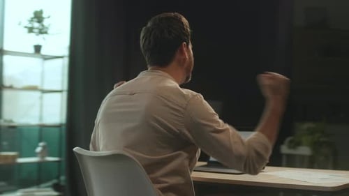 Happy Businessman Sitting at Desk Use Laptop Look on Screen Smiling and Dance in Office Satisfied