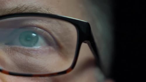 Close-up of Man with Glasses Reflecting Light