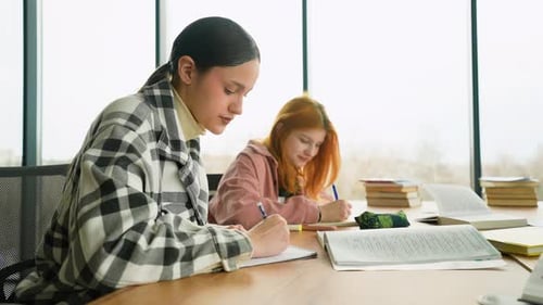 Students Studying and Taking Notes at Table