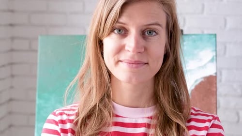 Woman Smiles Toward Camera in Red and White Shirt