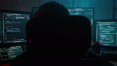 Hooded Hacker At Computers At Night
