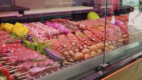 Display window butchers shop with meat arrangment either for grill.